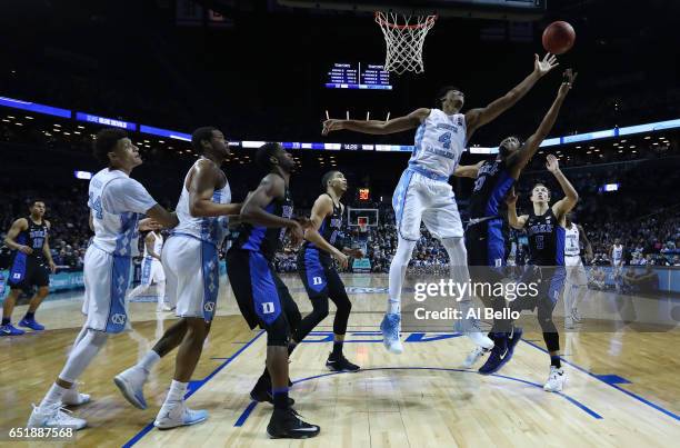 Isaiah Hicks of the North Carolina Tar Heels and Matt Jones of the Duke Blue Devils battle for the ball during the Semi Finals of the ACC Basketball...