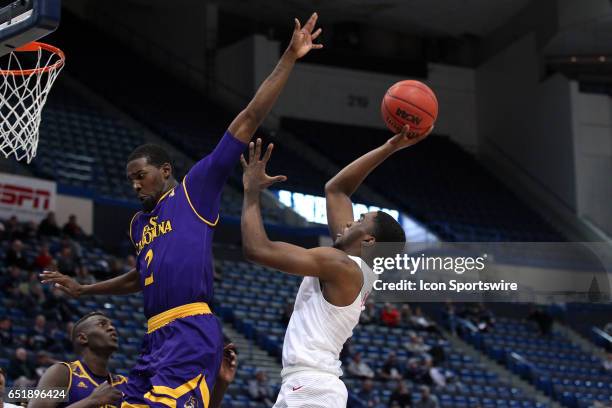 Mustangs guard Shake Milton and East Carolina Pirates guard Caleb White in action during the second half of the American Athletic Conference...