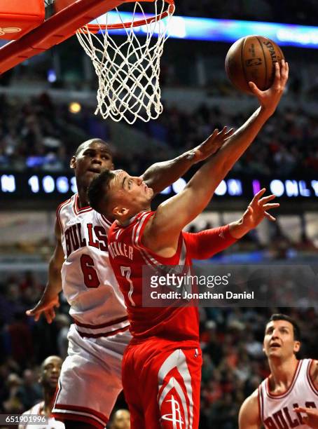 Sam Dekker of the Houston Rockets is fouled by Cristiano Felicio of the Chicago Bulls at the United Center on March 10, 2017 in Chicago, Illinois....