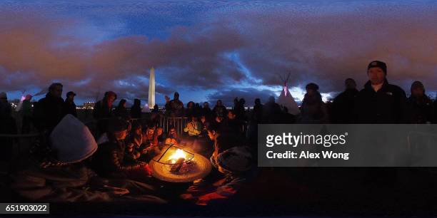 Activists gather around a sacred fire at the ground of Washington Monument after a day of protest March 10, 2017 in Washington, DC. The Standing Rock...
