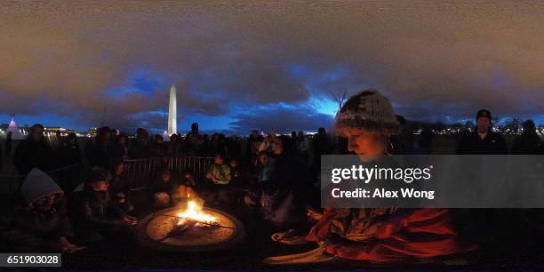 Activists gather around a sacred fire at the ground of Washington Monument after a day of protest March 10, 2017 in Washington, DC. The Standing Rock...