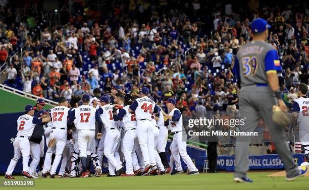 Adam Jones of the United States celebrates a walk off RBI single in the 10th inning during a Pool C game of the 2017 World Baseball Classic against...