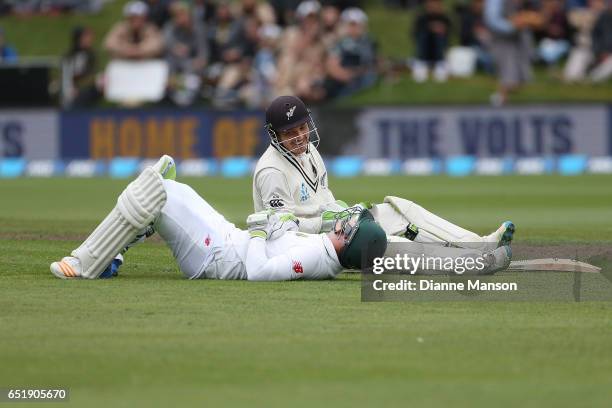 Dean Elgar of South Africa and BJ Watling of New Zealand collide during day four of the First Test match between New Zealand and South Africa at...
