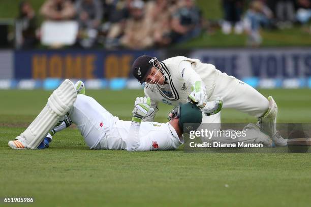 Dean Elgar of South Africa and BJ Watling of New Zealand collide during day four of the First Test match between New Zealand and South Africa at...