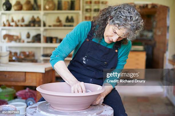 potter making bowl - concentration curl stock pictures, royalty-free photos & images