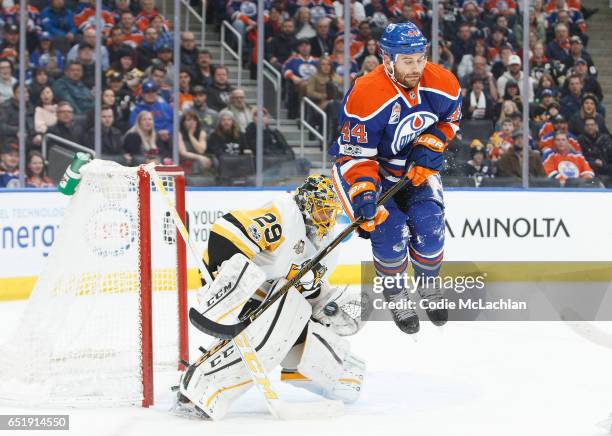 Zack Kassian of the Edmonton Oilers jumps in front of goalie Marc-Andre Fleury of the Pittsburgh Penguins on March 10, 2017 at Rogers Place in...