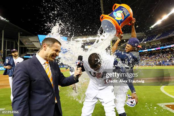 Adam Jones of Team USA gets doused with a water cooler by Chris Archer after Team USA beat Team Colombia in 10 innings in Game 2 Pool C of the 2017...
