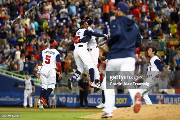 Adam Jones of Team USA celebrates with teammates after hitting a walk off single in the bottom of the 10th inning during Game 2 Pool C of the 2017...