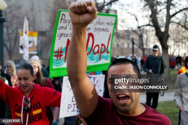 Native Americans and indigenous rights activists march and hold up signs in protest during a Native Nations March in Denver, Colorado on March 10,...