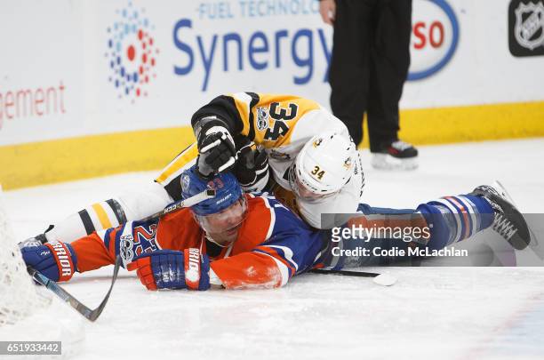 Matt Hendricks of the Edmonton Oilers is crushed by Tom Kuhnhackl of the Pittsburgh Penguins on March 10, 2017 at Rogers Place in Edmonton, Alberta,...