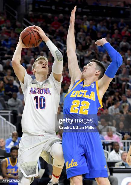 Lauri Markkanen of the Arizona Wildcats goes to the basket against TJ Leaf of the UCLA Bruins during a semifinal game of the Pac-12 Basketball...