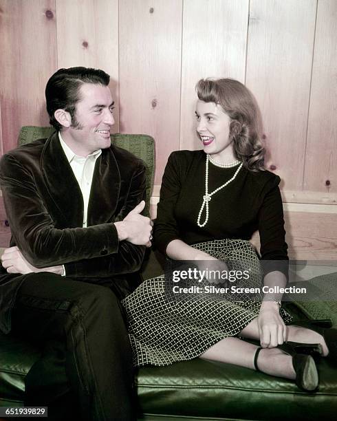 American actors Gregory Peck and Janet Leigh in conversation, circa 1955.