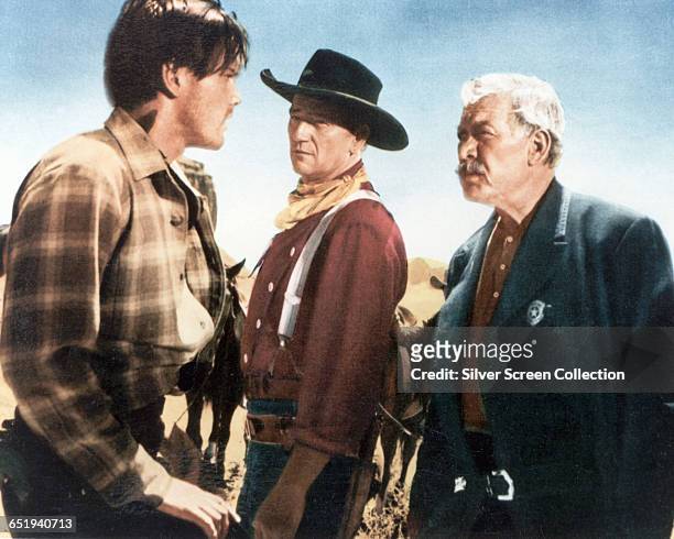 From left to right, Jeffrey Hunter as Martin Pawley, John Wayne as Ethan Edwards and Ward Bond as Rev. Capt. Samuel Johnston Clayton in 'The...