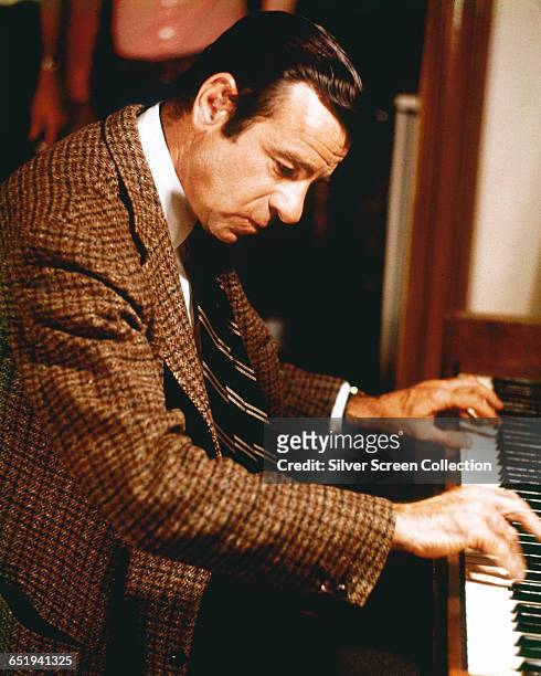 American actor Walter Matthau plays ragtime piano in the film 'Pete 'n' Tillie', 1972.
