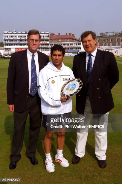 India's Sachin Tendulkar is presented with a dish to mark his 100th test appearance for India with Paul Sheldon