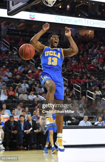 Ike Anigbogu of the UCLA Bruins reacts after dunking against the Arizona Wildcats during a semifinal game of the Pac-12 Basketball Tournament at...