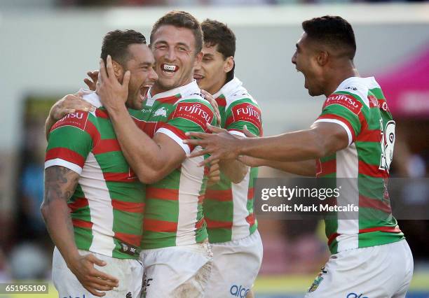 John Sutton of the Rabbitohs celebrates scoring a try with team mates during the round two NRL match between the Manly Sea Eagles and the South...