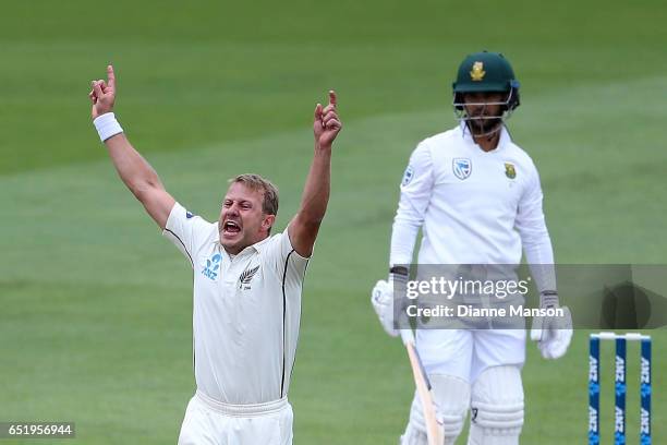 Neil Wagner of New Zealand celebrates the dismissal of JP Duminy of South Africa during day four of the First Test match between New Zealand and...