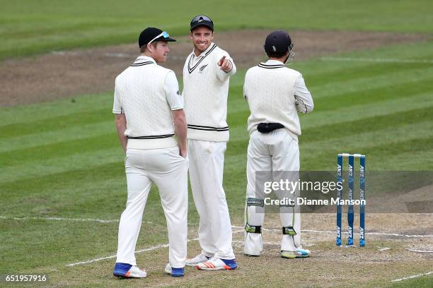 Jimmy Neesham and Tim Southee of New Zealand look on during day four of the First Test match between New Zealand and South Africa at University Oval...