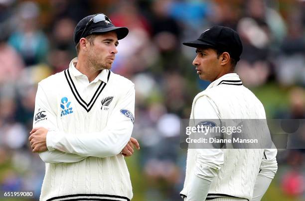 Tim Southee and Jeet Raval of New Zealand chat during day four of the First Test match between New Zealand and South Africa at University Oval on...