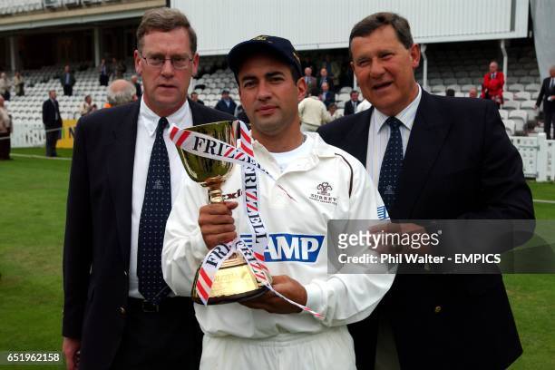 Surrey CCC Chief Executive Paul Sheldon and Chairman Mike Soper with Captain Adam Hollioake holding the Frizzell County Championship Trophy