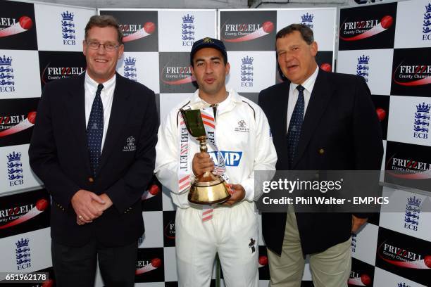 Surrey CCC Chief Executive Paul Sheldon and Chairman Mike Soper with Captain Adam Hollioake holding the Frizzell County Championship Trophy