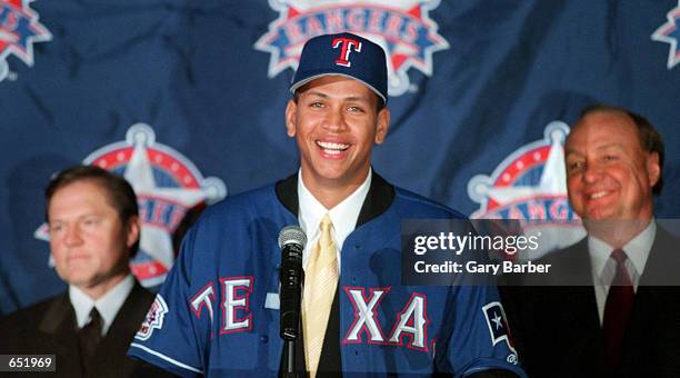 Newly signed Texas Ranger Alex Rodriguez, center, is introduced to the media by club owner Tom Hicks, right, and Rodriguez' agent Scott Boras during...