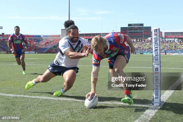 Nathan Ross of the Knights scores a try during the round two NRL match between the Newcastle Knights and the Gold Coast Titans at McDonald Jones...