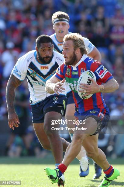 Nathan Ross of the Knights runs the ball during the round two NRL match between the Newcastle Knights and the Gold Coast Titans at McDonald Jones...