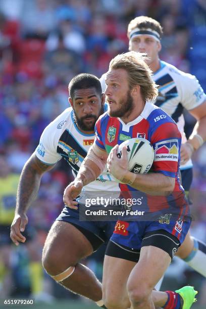 Nathan Ross of the Knights runs the ball during the round two NRL match between the Newcastle Knights and the Gold Coast Titans at McDonald Jones...