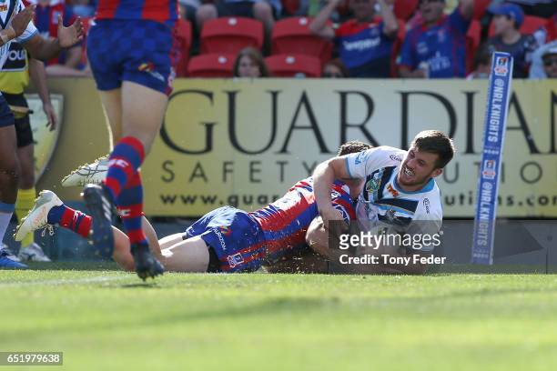 Joe Greenwood of the Titans scores a try during the round two NRL match between the Newcastle Knights and the Gold Coast Titans at McDonald Jones...