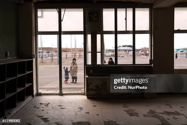 The local people gather round the abandoned Arahama elementary school at Wakabayashi ward, MIyagi prefecture at 11 March 2017. Six years have passed...