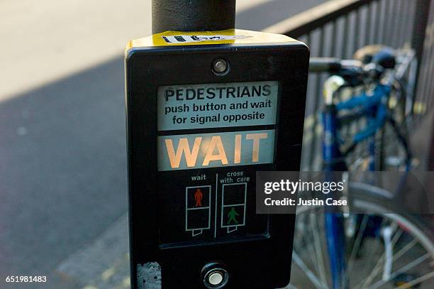 pedestrians wait sign at traffic light - wait sign sign stock pictures, royalty-free photos & images