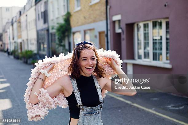 young woman running happily through yard - overall stock pictures, royalty-free photos & images