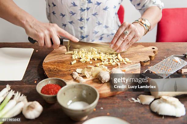 making kimchi: chopping ginger - ginger stock-fotos und bilder
