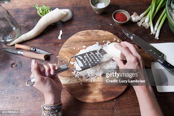 making kimchi: grating daikon - dikon radish stock pictures, royalty-free photos & images