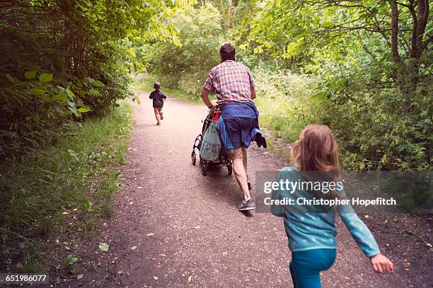 heading home through a park - lean in collection father stock-fotos und bilder