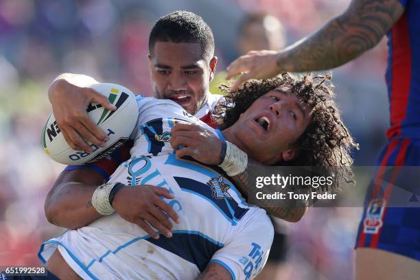 Kevin Proctor of the Titans is tackled during the round two NRL match between the Newcastle Knights and the Gold Coast Titans at McDonald Jones...