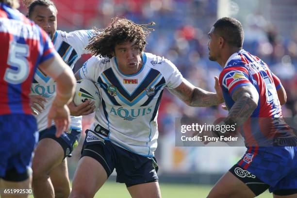 Kevin Proctor of the Titans looks to fend off the Knights defence during the round two NRL match between the Newcastle Knights and the Gold Coast...