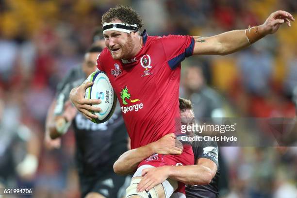 Scott Higginbotham of the Reds makes a break during the round three Super Rugby match between the Reds and the Crusaders at Suncorp Stadium on March...