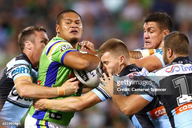 Joseph Leilua of the Raiders is tackled during the round two NRL match between the Canberra Raiders and the Cronulla Sharks at GIO Stadium on March...