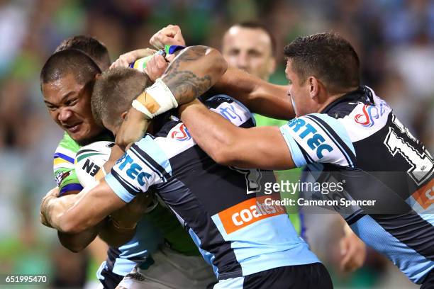 Joseph Leilua of the Raiders is tackled during the round two NRL match between the Canberra Raiders and the Cronulla Sharks at GIO Stadium on March...