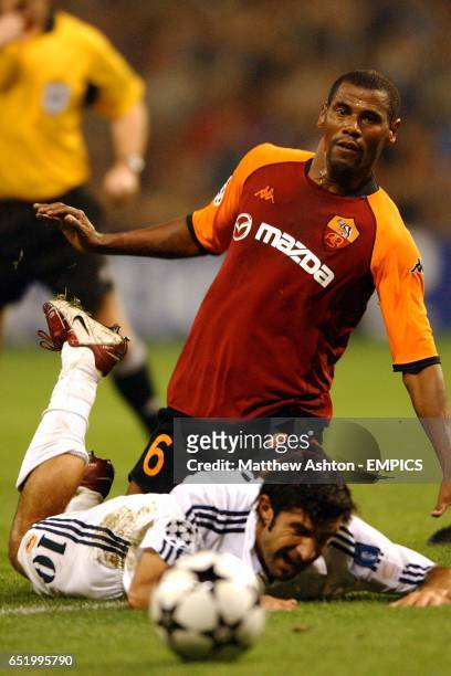 Real Madrid's Luis Figo goes down following a challenge from AS Roma's Aldair