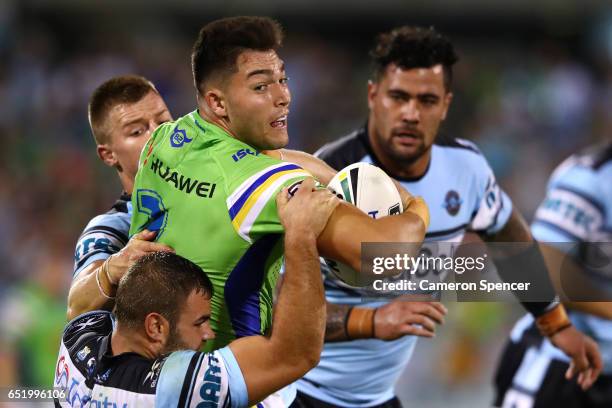 Nikola Cotric of the Raiders is tackled during the round two NRL match between the Canberra Raiders and the Cronulla Sharks at GIO Stadium on March...