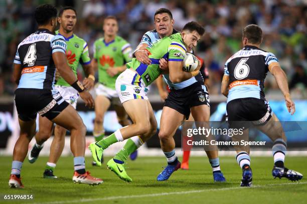 Nikola Cotric of the Raiders is tackled during the round two NRL match between the Canberra Raiders and the Cronulla Sharks at GIO Stadium on March...