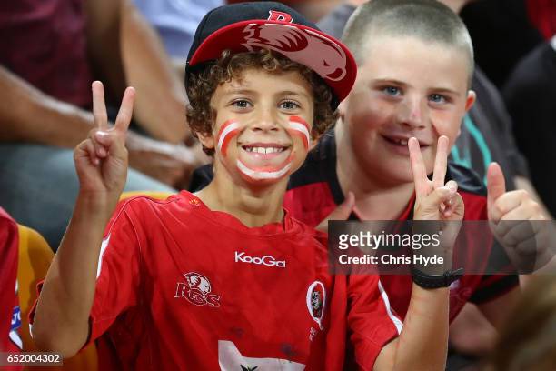 Fans cheer during the round three Super Rugby match between the Reds and the Crusaders at Suncorp Stadium on March 11, 2017 in Brisbane, Australia.
