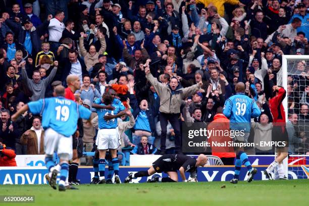 Manchester City's Shaun Goater is congratulated by Eyal Berkovic as Manchester United's Juan Veron, Fabien Barthez and Laurent Blanc turn away...