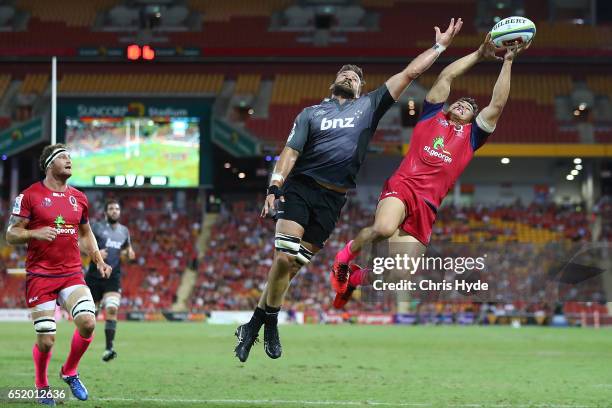 Heiden Bedwell-Curtis of Crusaders and Izaia Perese of the Reds compete for the ball during the round three Super Rugby match between the Reds and...