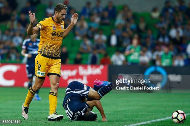 Fahid Ben Khalfallah of the Victory falls after contesting the ball with Rostyn Griffiths of the Glory during the round 23 A-League match between...