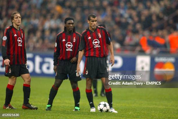 Milan's Massimo Ambrosini, Clarence Seedorf and Rivaldo stand over a freekick